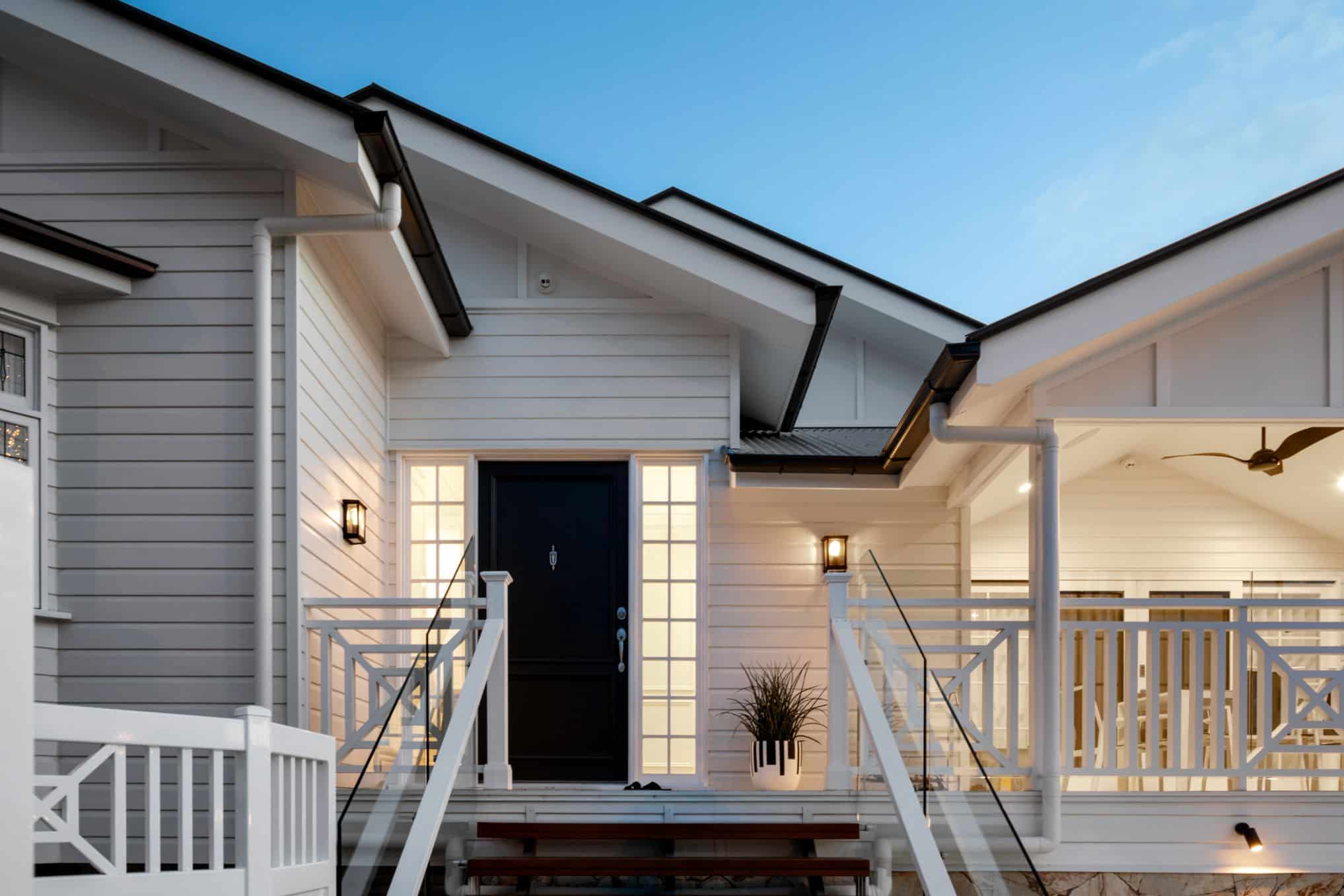 Brisbane home exterior with freshly painted white weatherboards, front entry and outdoor lighting